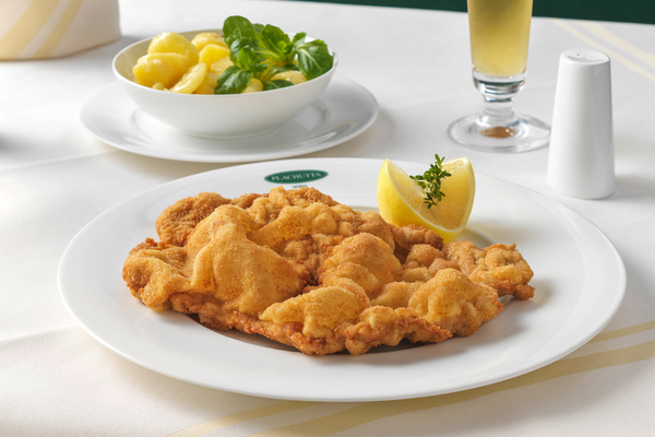 Green grapes are crushed and juiced in an industrial machine during wine production.