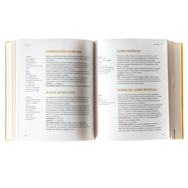 A white plate with a bread roll and three spoonfuls of flavored butter or spread, garnished with herbs.