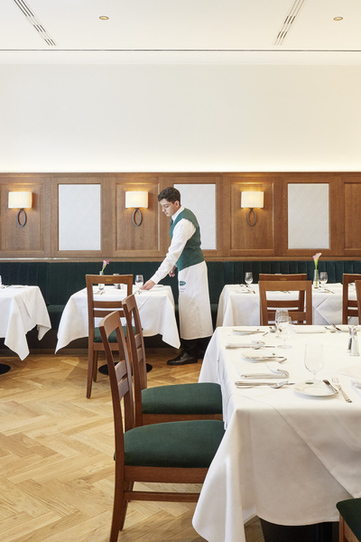 A bottle of Fuhrgassl-Huber Wiener Gemischter Satz white wine with a black cap and white label.