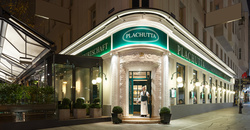 Timber-framed loft with exposed rafters, insulation and a window that lets in natural light.