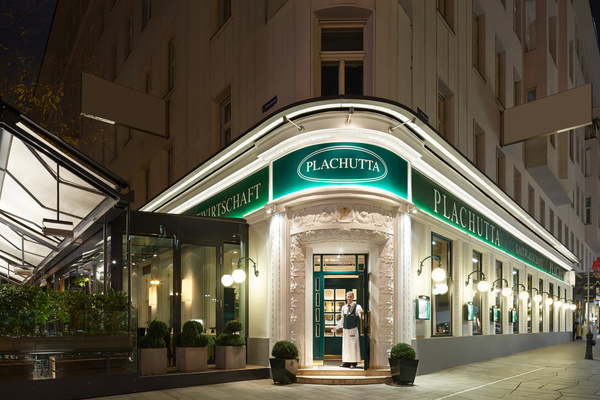 Timber-framed loft with exposed rafters, insulation and a window that lets in natural light.